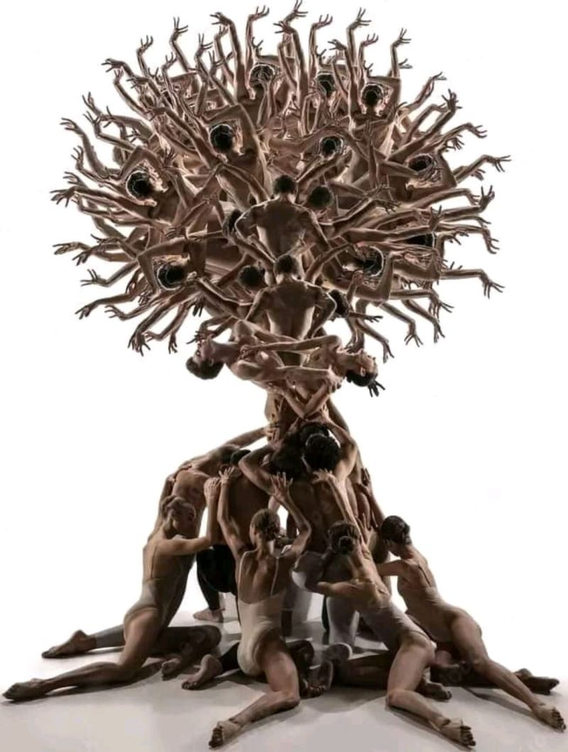 Intricate bronze sculpture of multiple human figures intertwined in a dynamic, expressive pose.
